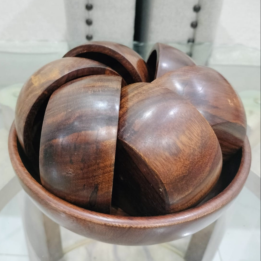 Wooden ball puzzle on a white surface with a blurred background