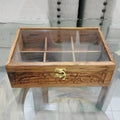 Wooden jewelry box with glass top on a round glass table