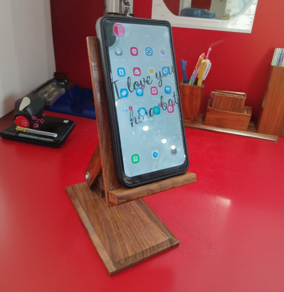 Smartphone on a wooden stand with a colorful display against a red background
