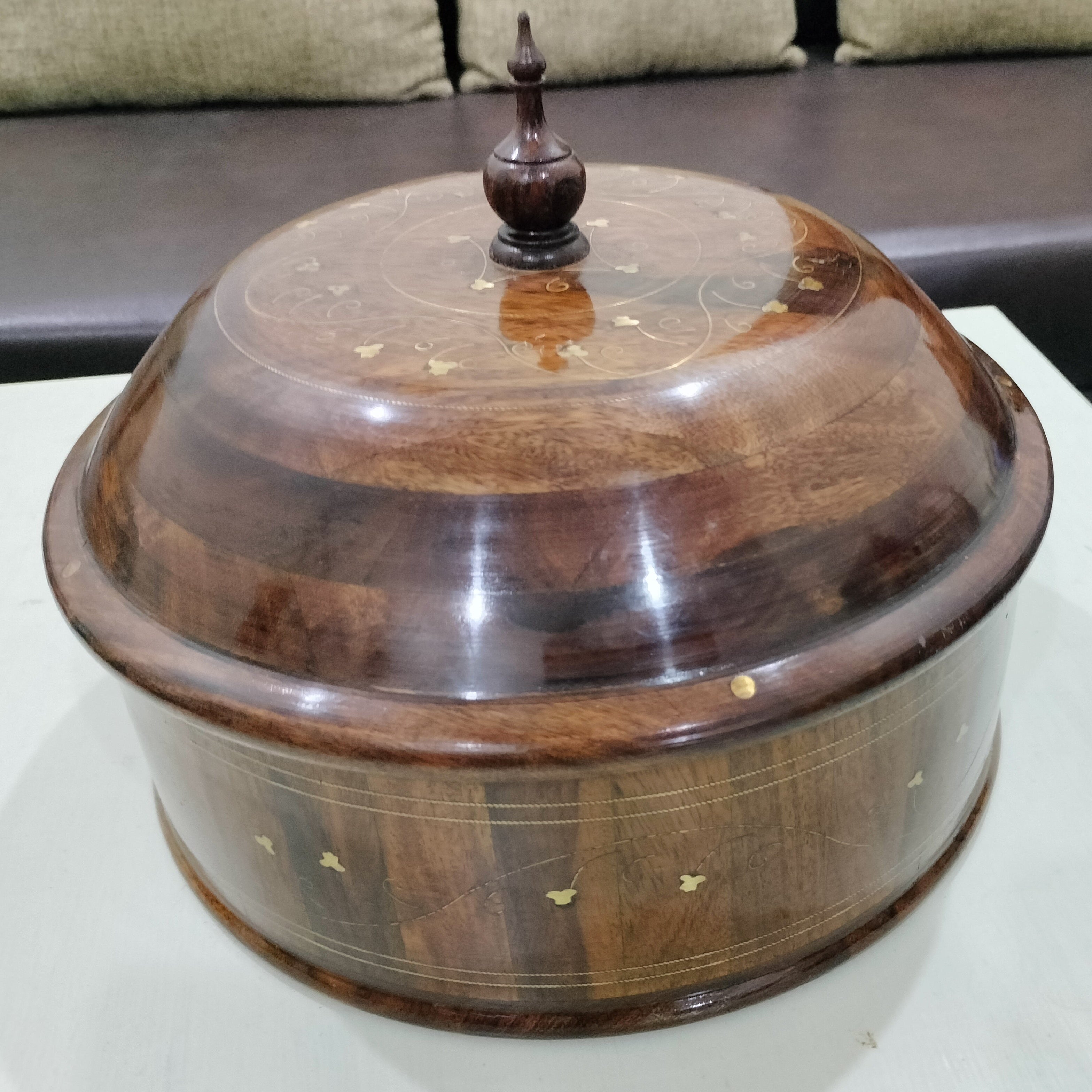 Wooden decorative box with a lid on a white surface